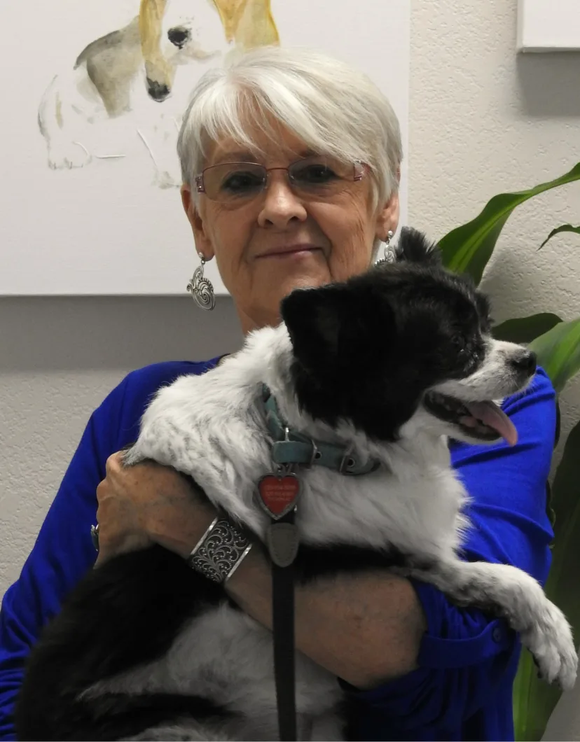 Barb holding a black and white dog